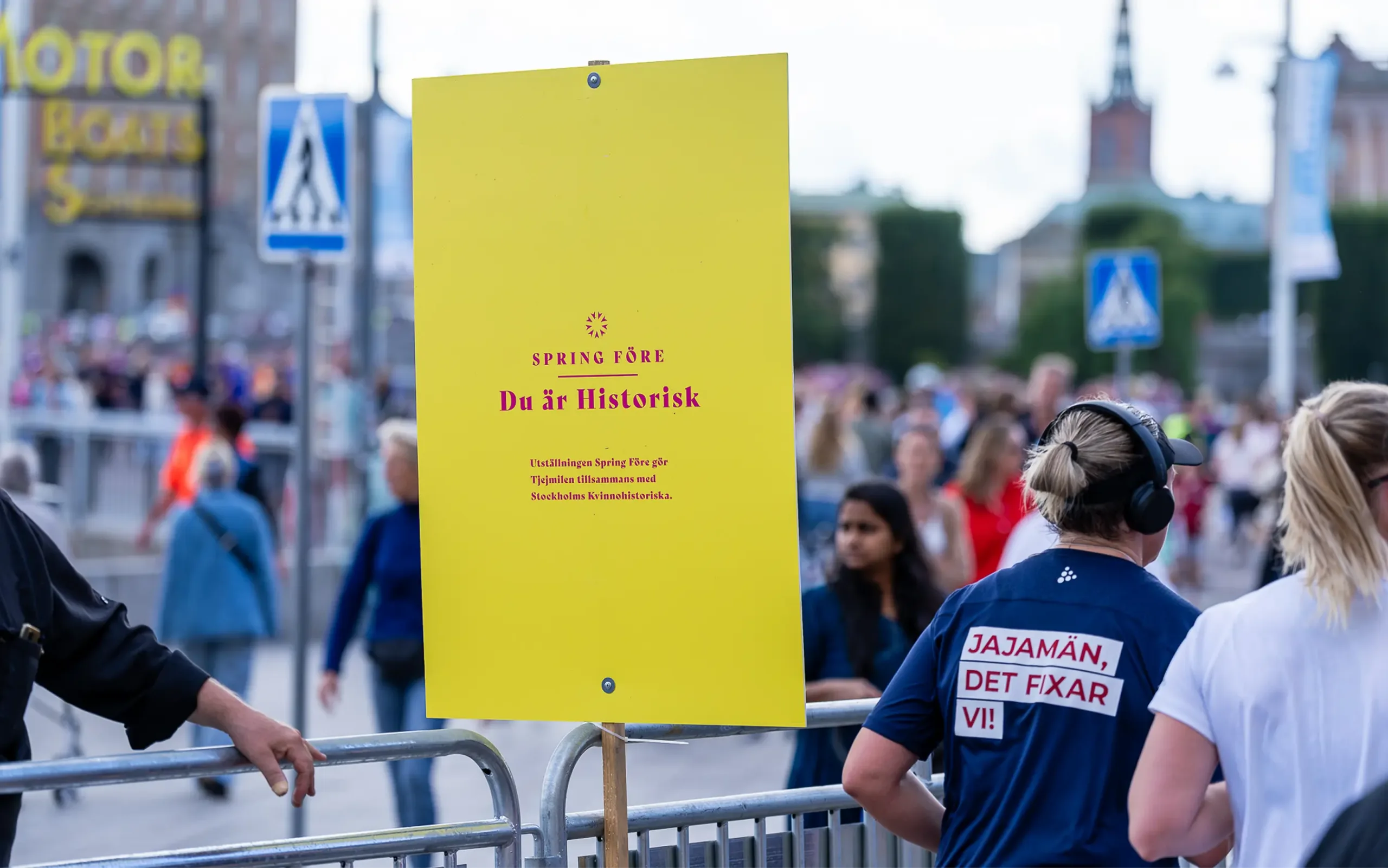 Skylt för tjejmilen tillsammans med kvinnohistoriska