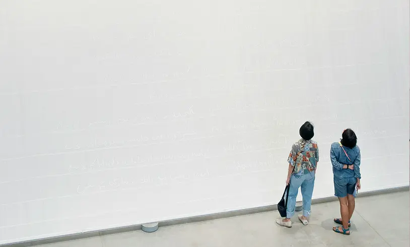 två personer vid stor vägg